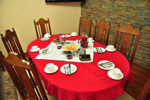 a table with a red table cloth on a red table at Hospedaje klickmann in Temuco
