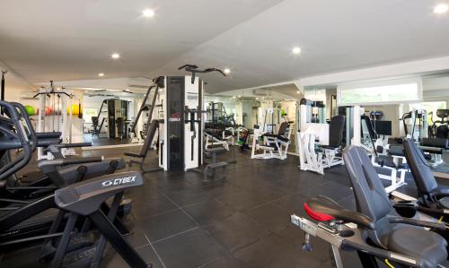 a gym with a lot of treadmills and machines at Galley Bay Resort & Spa - All Inclusive in Saint Johnʼs