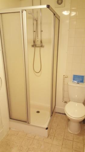 a bathroom with a shower and a toilet at Silver Ridge, 2 House O` Hill in Newton Stewart