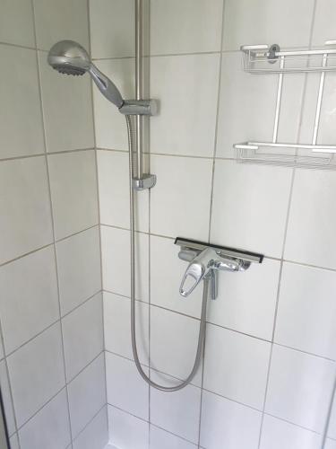 a shower with a shower head in a bathroom at Ferienhaus Zinnowitz in Zinnowitz