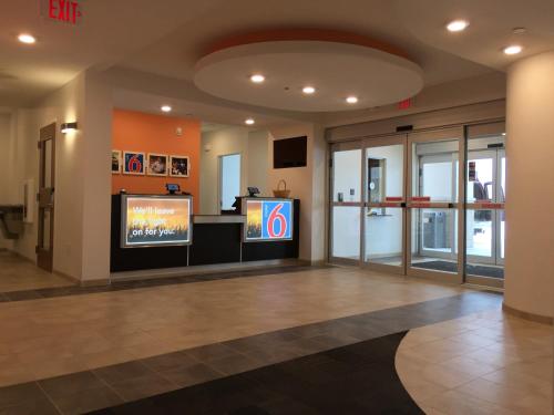 a lobby with two televisions in a building at Motel 6-Mankato, MN in Mankato