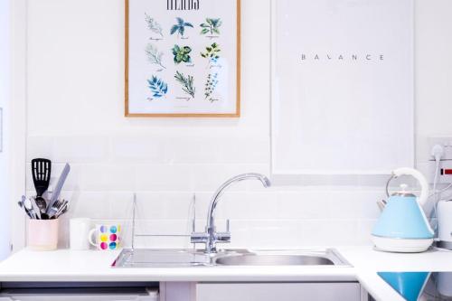 a kitchen with a sink and a picture on the wall at The Annexe in Bournemouth