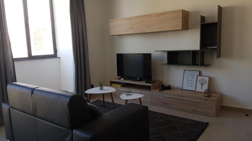 
A television and/or entertainment center at Lvl2 Apartment in the heart of San Gwann
