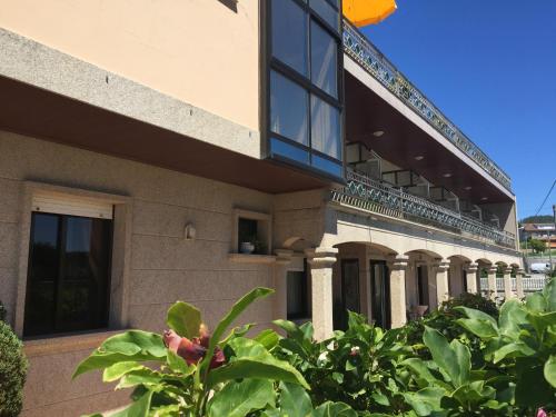 a building with plants in front of it at Hotel Florida in A Lanzada