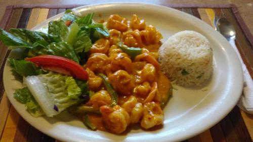 a plate of food with pasta and vegetables on a table at Hotel Azteca de Oro Mexicali in Mexicali
