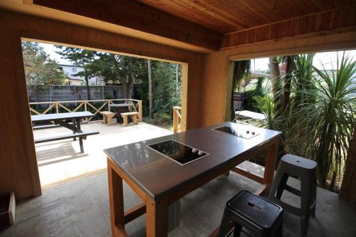 a dining room with a table and a patio at Te Anau Lakefront Backpackers in Te Anau