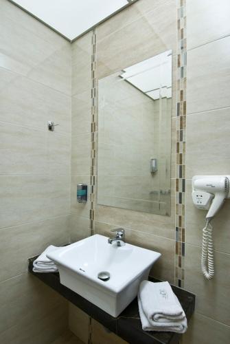 a bathroom with a sink and a mirror at Villa Elia in Veria
