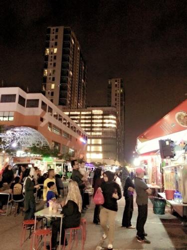 a group of people at an outdoor market at night at Evo Bangi Duplex Homestay D' Imahzzz - 3BR or 2BR in Bangi