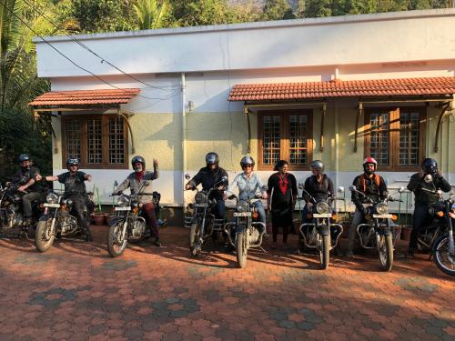 a group of people on motorcycles parked in front of a building at Green Shades in Munnar