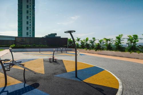 a park with benches and lights on top of a building at Comfort Zone Premium Guesthouse @ Evo Bangi in Bangi