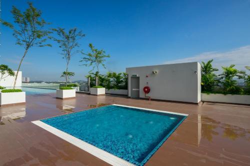 a swimming pool on the roof of a building at Comfort Zone Premium Guesthouse @ Evo Bangi in Bangi