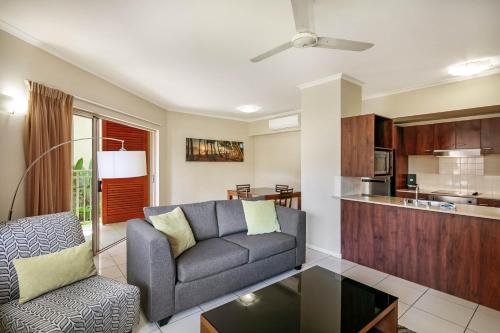 a living room with a couch and a table at Mantra Amphora in Palm Cove