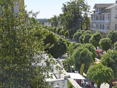 a street with a row of trees and buildings at Villa Li - Fewo 06 "Sonneninsel" in Ostseebad Sellin