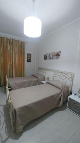 Ένα ή περισσότερα κρεβάτια σε δωμάτιο στο B&b I portici