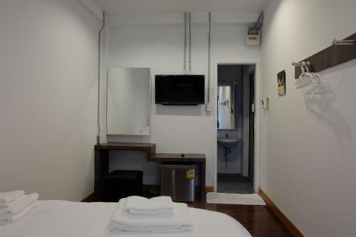 a hospital room with two beds and a television at F Plus F Hostel in Chiang Mai