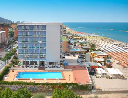 a hotel with a swimming pool next to a beach at Hotel Majestic in Pesaro