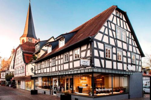 a black and white building with a church at Ferienwohnung Stadtgarten in Michelstadt