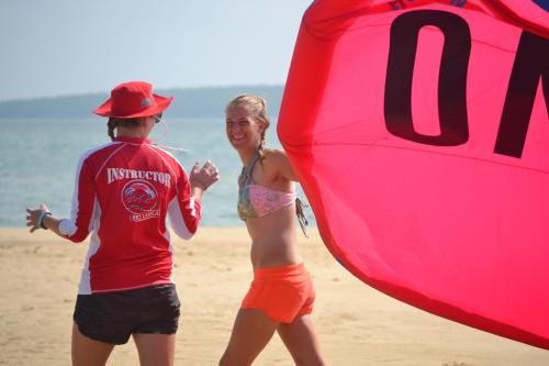 a man and a woman walking on the beach at Dolphin Beach Resort in Kalpitiya