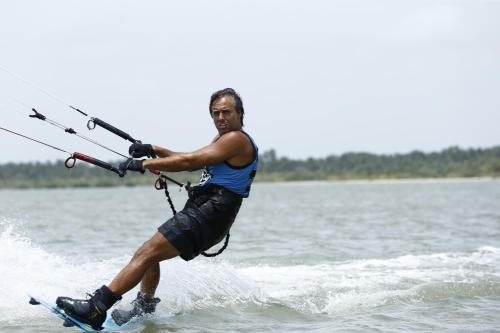 a man is water skiing on the water at Dolphin Beach Resort in Kalpitiya