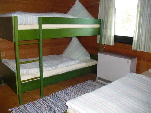 a bunk bed room with two bunk beds next to a window at Ferienhaus Schallerhof in Kupferberg