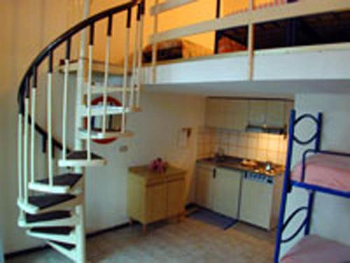 a small kitchen with a bunk bed and a staircase at La Pineta in Albenga