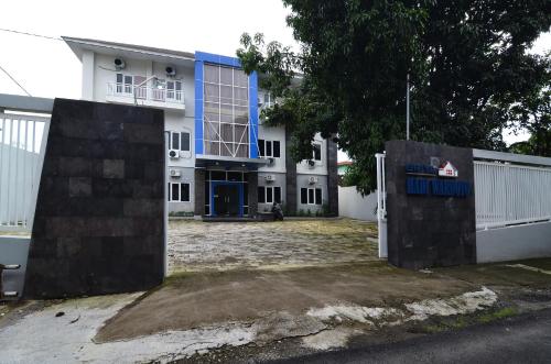a building with a gate in front of it at RedDoorz near Museum Keraton Surakarta in Solo