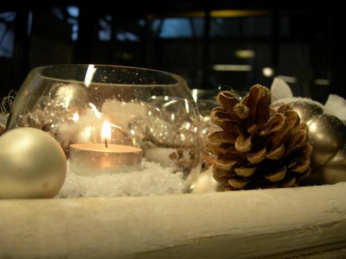 a table topped with christmas decorations and a candle at Hotel Crystal Interlaken in Interlaken