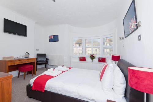 a hotel room with a bed and a desk at Hamptons Brighton in Brighton & Hove
