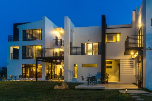 a large white building with chairs in front of it at Lin's Forest in Hengchun