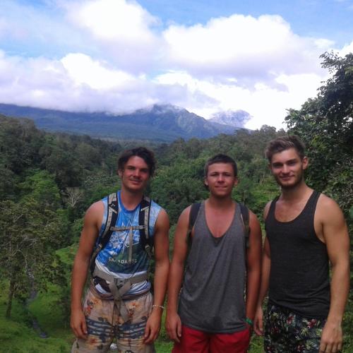 a group of three men standing on top of a mountain at Tereng Wilis Jungle Inn in Tetebatu