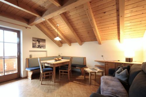 a living room with a table and a couch at Appartements Barbara in Sesto