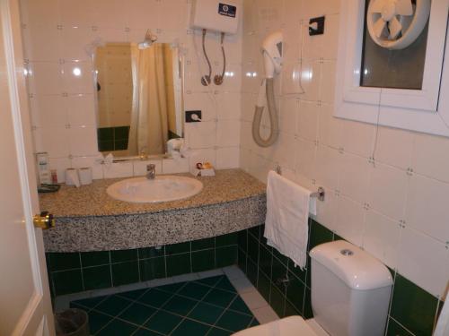 a bathroom with a sink and a toilet at Logaina Sharm Resort in Sharm El Sheikh