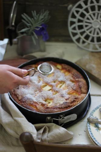 a person using a spoon to serve a dish of food at Ca'Vermiglia B&B in Bologna