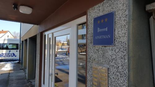 a sign on the side of a building at Apartmani Ana in Szlatina