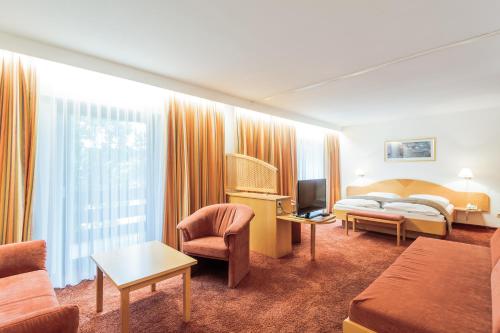 En eller flere senge i et værelse på Hotel Schützenhof