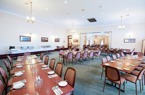 a large room with tables and chairs in it at Standpipe Golf Motor Inn in Port Augusta