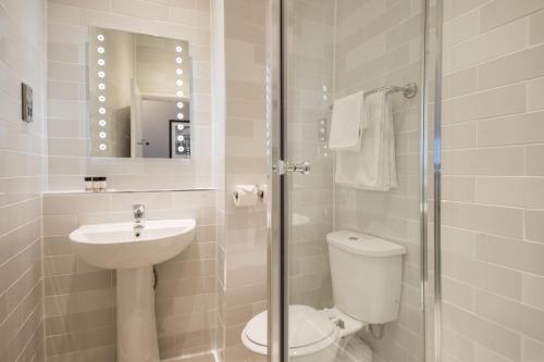 a bathroom with a toilet and a sink and a shower at The Town House by Innkeeper's Collection in Norwich