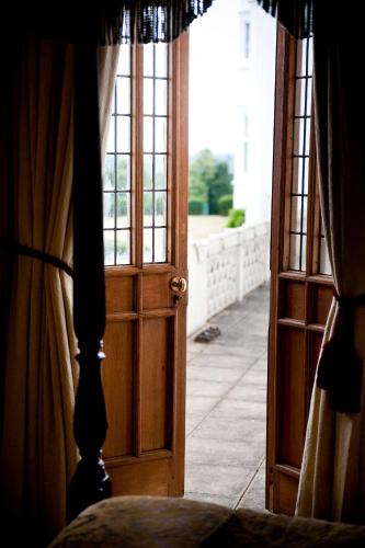 an open door to a room with a window at Danesfield House Hotel And Spa in Marlow