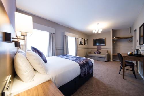 a hotel room with a bed and a desk at The Town House by Innkeeper's Collection in Norwich