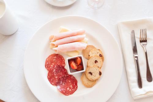 a plate of food with sausage and bread on a table at Hostal Antolín in Redondela