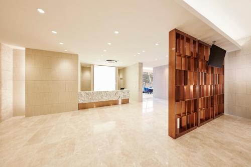 a large lobby with a large wall of shelves at Skybay Hotel Gyeongpo in Gangneung