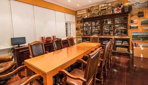 a dining room with a table and chairs at Hout Bay Manor in Hout Bay