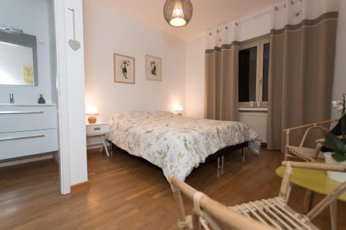 a bedroom with a bed and a desk and a chair at Le Domaine des Prés in Lachambre