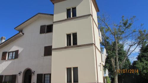 a white building with black windows at Locanda San Marino Al Coppo in Monte Grimano Terme
