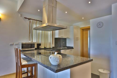a kitchen with a island with a vase on the counter at Sybaris Suites & Residences in Juan Dolio