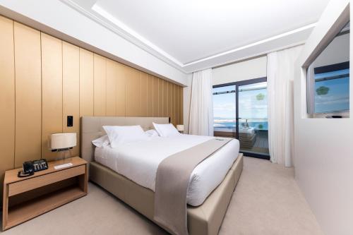 a bedroom with a large bed and a television at GPRO Valparaiso Palace & Spa in Palma de Mallorca