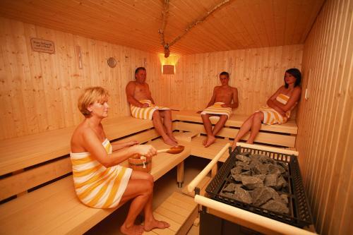 a group of people sitting in a sauna at Familienhotel Petschnighof in Diex