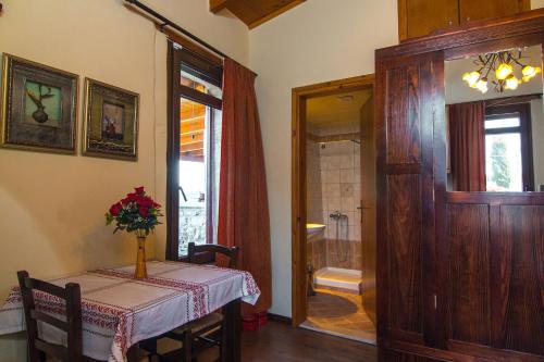 a dining room with a table and a shower at Villa Morfeas - Traditional Cretan Escape with BBQ in Dhamavólos