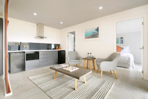 a kitchen and living room with a table and chairs at The Beach House North Wollongong in Wollongong