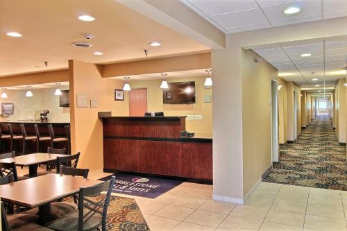a waiting room at a hospital with tables and chairs at AmeriVu inn and Suites - Crookston in Crookston